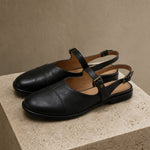 Positano Leather Slingback Flat Sandals — Black, studio product shot